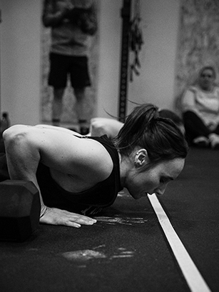 Atleta a realizar um exercício no chão durante o Murph